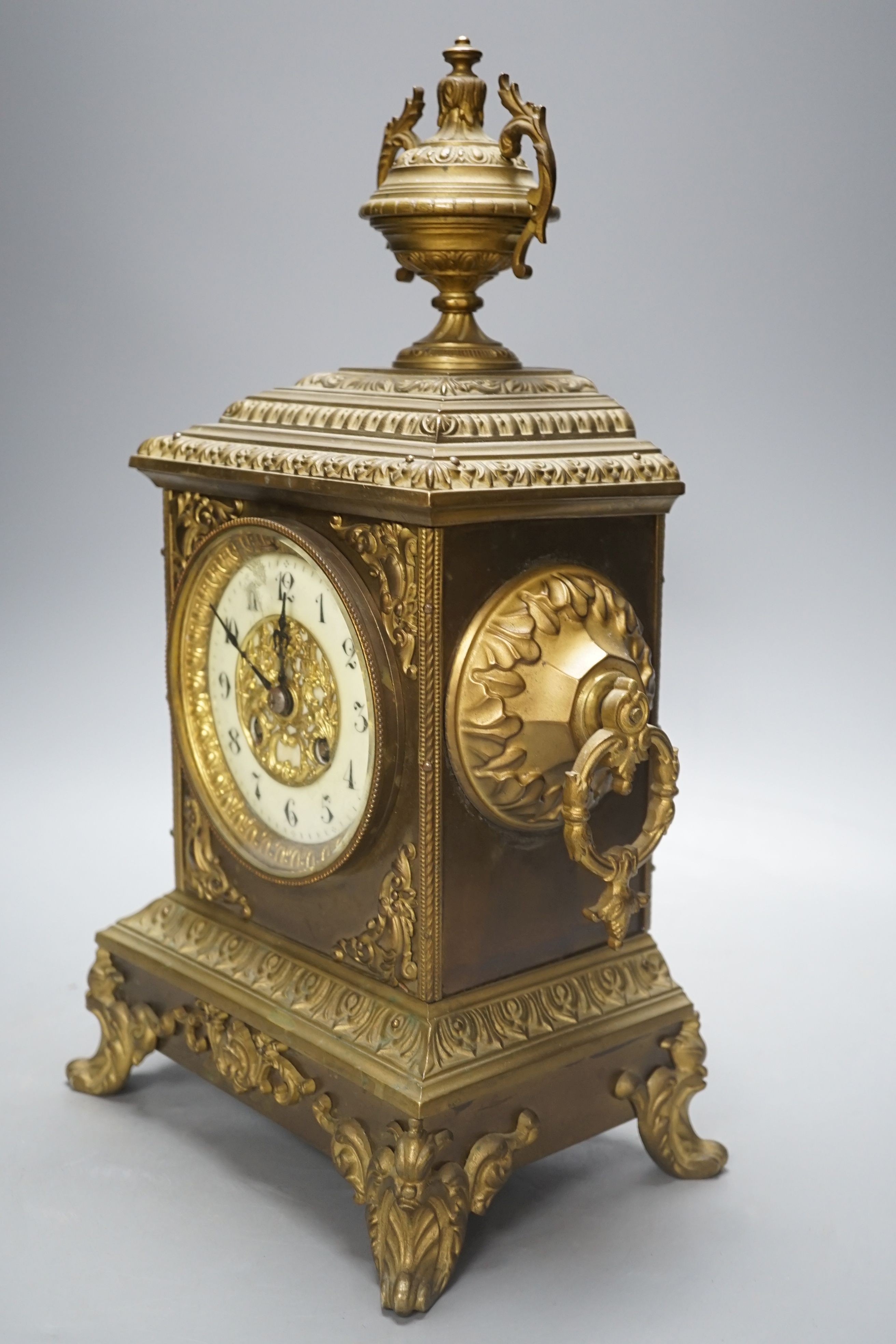 An early 20th century brass mantel clock, 40 cms high.